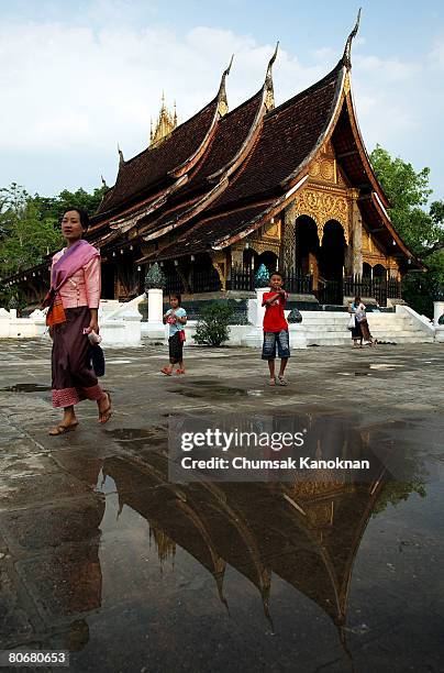 Laos people leave Wat Xieng Thong after offering food to Buddhist monks during the Songkran festival on April 15 in Luang Prabang, Laos. The Songkran...