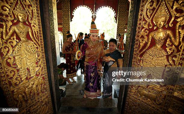 Laos women in acient dress, walk in Wat Xieng Thong during the Songkran festival on April 15 in Luang Prabang, Laos. The Songkran Festival runs from...