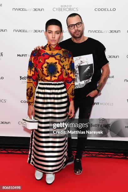 Alina Sueggler and designer Marcell von Berlin are seen during the Marcell von Berlin 'Genesis' collection presentation on July 3, 2017 in Berlin,...