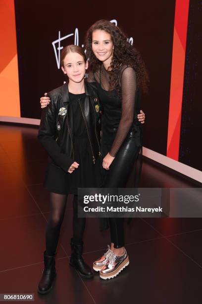 Betty Taube poses with Gerit Kling's daughter during the Marcell von Berlin 'Genesis' collection presentation on July 3, 2017 in Berlin, Germany.