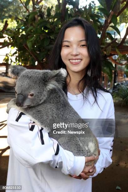 Model Xiao Wen Ju poses with a koala at Currumbin Wildlife Sanctuary on the Gold Coast, Queensland.