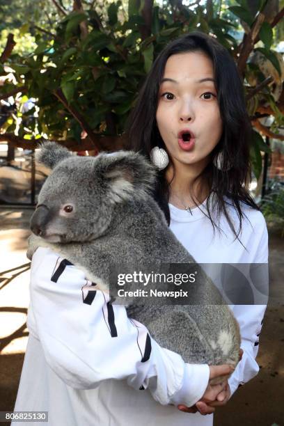 Model Xiao Wen Ju poses with a koala at Currumbin Wildlife Sanctuary on the Gold Coast, Queensland.