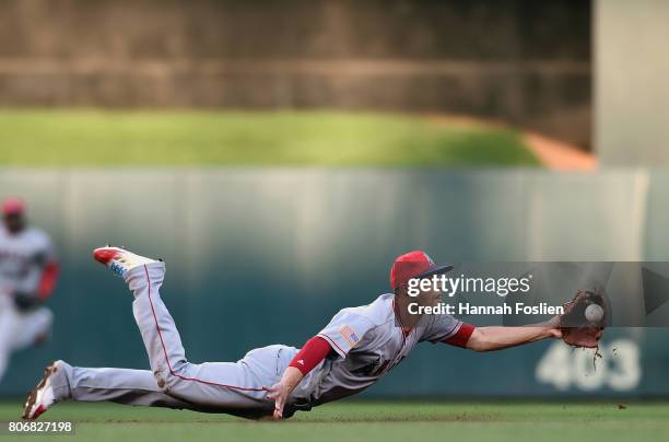 Andrelton Simmons of the Los Angeles Angels of Anaheim flips the ball to second base to get out Jason Castro of the Minnesota Twins during the second...