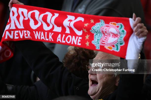 Liverpool fan sings 'You'll Never Walk Alone' during a service at Anfield football stadium in Liverpool to mark the 19th anniversary of the...