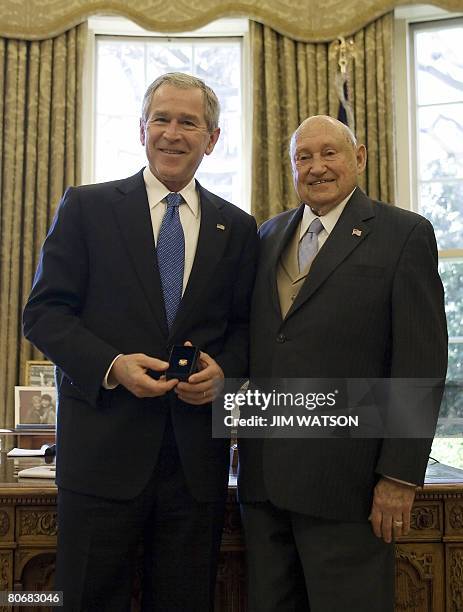 President George W. Bush presents the Lifetime President's Volunteer Service Award to Chick-Fil-A founder Truett Cathy in the Oval Office of the...