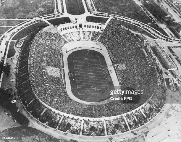 Crowds watching an American football match at the Los Angeles Memorial Coliseum, circa 1930.