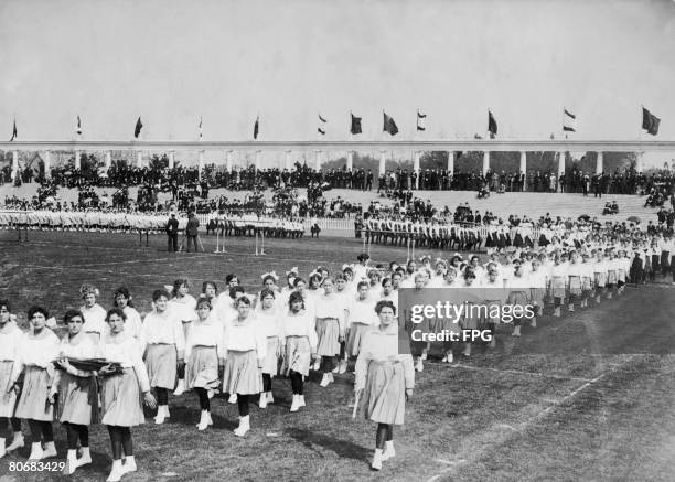 Girls taking part in a parade at the opening ceremony of the Antwerp Olympics at the Olympisch Stadion, 20th April 1920.