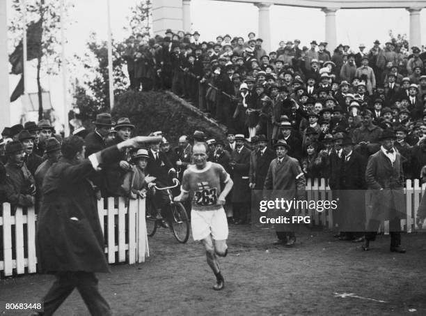 Finnish runner Hannes Kolehmainen entering the Olympisch Stadion to win the gold medal in the Marathon, 22nd August 1920.