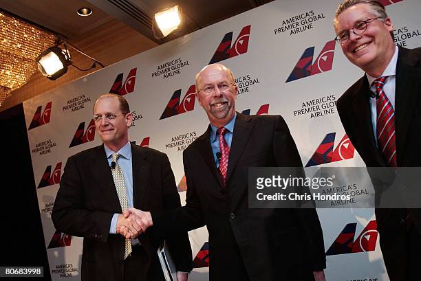 Doug Steenland , President and CEO of Northwest Airlines, shakes hands with Delta CEO Richard Anderson while Edward Bastian , Delta President and...