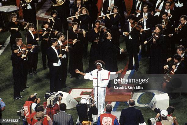Singer Whitney Houston sings the National Anthem before the New York Giants took on the Buffalo Bills in Super Bowl XXV at Tampa Stadium on January...