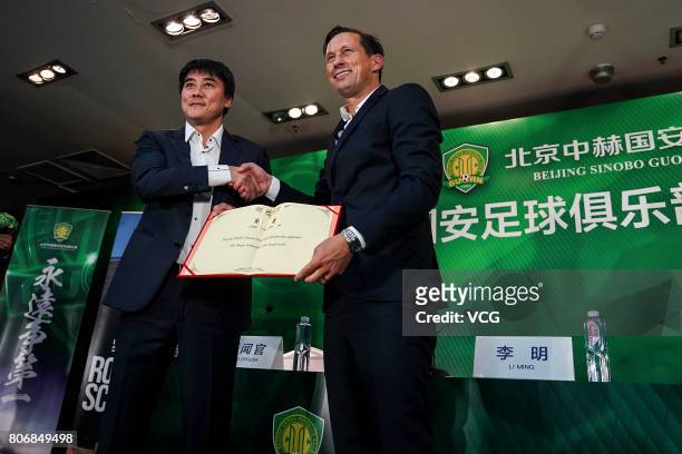 Guoan's general manager Li Ming and German football manager Roger Schmidt attend a press conference as Roger Schmidt joins Beijing Guoan FC on July...