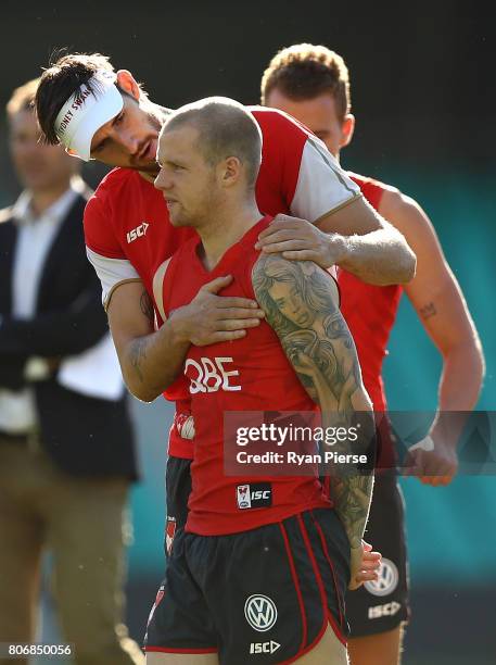 Sam Naismith of the Swans inspects a cut on the eye of Zak Jones of the Swans during a Sydney Swans AFL training session at Sydney Cricket Ground on...