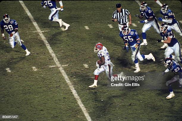 Running back Thurman Thomas of the Buffalo Bills races upfield and away from the New York Giants defense in Super Bowl XXV at Tampa Stadium on...