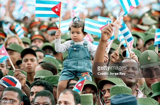 Girl waves a cuban flag May 1, 2001 during May Day celebrations at the Revolution Plaza in Havana, Cuba.