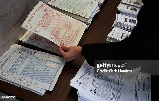 Woman picks up tax forms in the lobby of the Farley Post Office April 15, 2008 in New York City. The Farley Post Office is New York City's largest,...