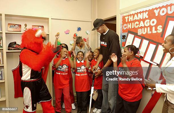 Tyrus Thomas of the Chicago Bulls along with team mascot Benny the Bull cut a ribbon to officially open a new Chicago Bulls Reading and Learning...
