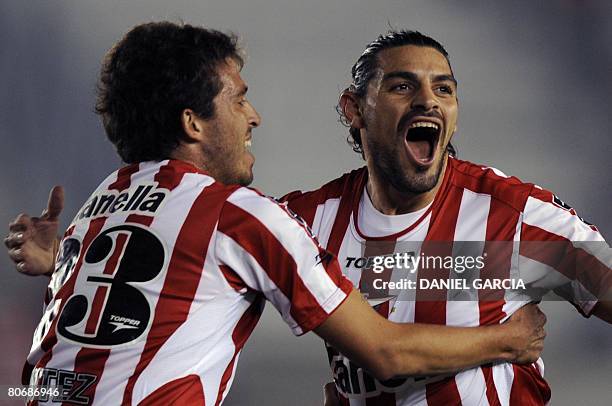 Forward Leandro Lazzaro of Estudiantes celebrates with teammate defender Jose Basanta after he scored the first goal against Deportivo Cuenca during...