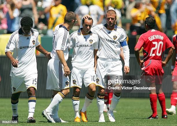 David Beckham and Greg Vanney of the Los Angeles Galaxy congratulate Landon Donvoan after Donovan equalized with a goal against Toronto FC in the...