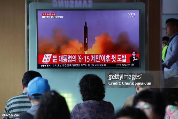People watch a television broadcast reporting the North Korean missile launch at the Seoul Railway Station on July 4, 2017 in Seoul, South Korea....