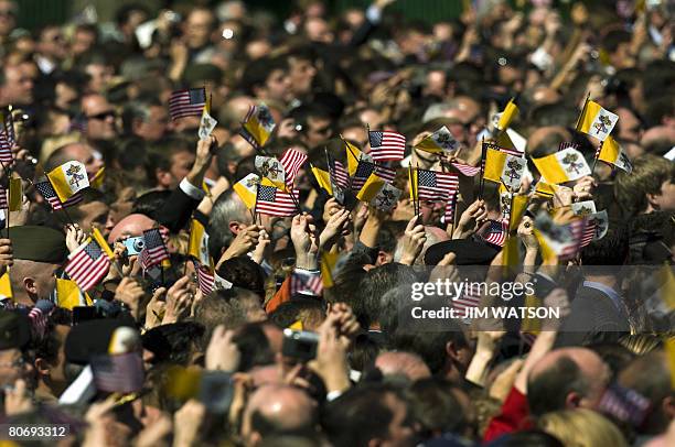 Members of the crowd wave American and Vatican flags as Pope Benedict XVI and US President George W. Bush participate in an Arrival Ceremony on the...