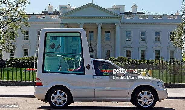 Pope Benedict XVI waves as he rides in the Popemobile as he departs the White House after meeting with U.S. President George W. Bush April 16, 2008...