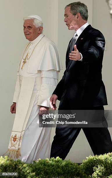 Pope Benedict XVI and U.S. President George W. Bush talk while walking to the Oval Office along the Rose Garden colonnade at the White House April...