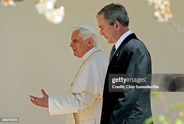 Pope Benedict XVI and U.S. President George W. Bush talk while walking to the Oval Office along the Rose Garden colonnade at the White House April...