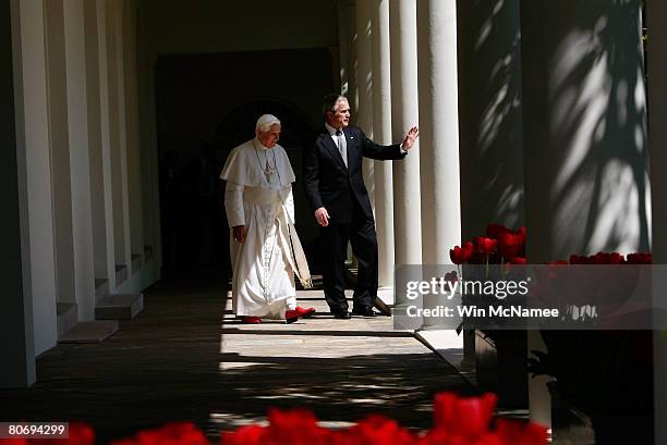 Pope Benedict XVI and U.S. President George W. Bush walk along the Colonnade before meeting in the Oval Office following an arrival ceremony at the...