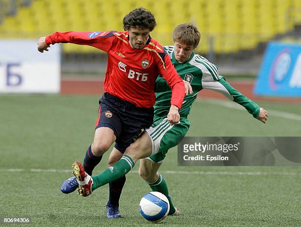 Yuri Zhirkov of PFC CSKA Moscow challenges for the ball with 2 of FC Tom Tomsk during the Russian Cup semi-final football match between PFC CSKA and...
