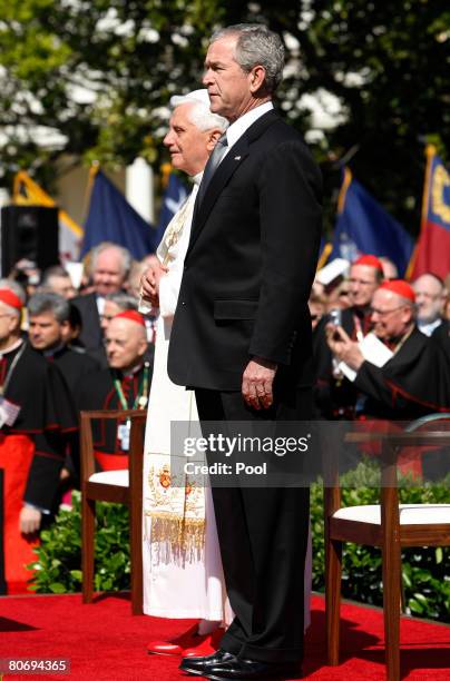 Pope Benedict XVI and U.S. President George W. Bush listen to the Vatican's National Anthem during an arrival ceremony on the South Lawn at the White...