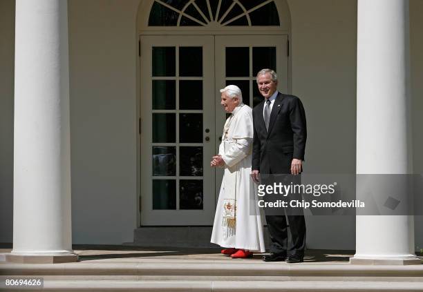 Pope Benedict XVI and U.S. President George W. Bush pause for photographers while walking to the Oval Office along the Rose Garden colonnade at the...
