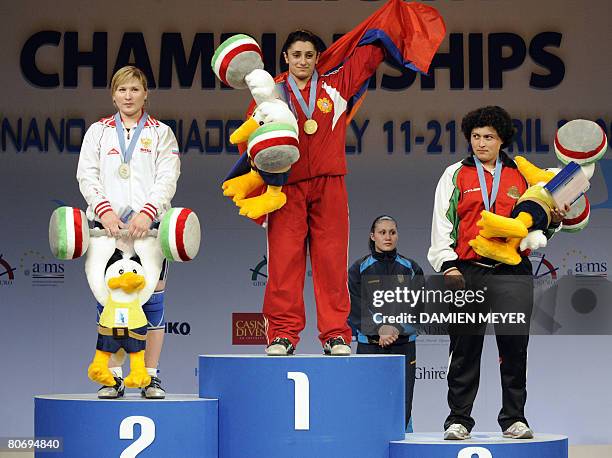 Gold medalist Armenia's Nazik Avdalyan flanked by silver medalist Russia's Tatiana Matveeva and bronze medalist Bulgarian Slaveyka Ruzhinska waves...