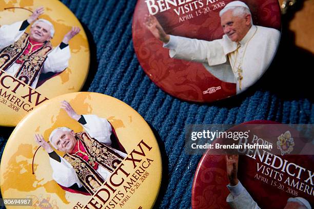 Jerryell Cannon, a flag and button vendor from Tampa, FL, displays his wares along the route Pope Benedict XVI will take in the Popemobile from the...