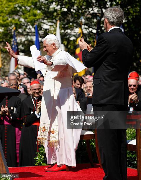 Pope Benedict XVI waves and U.S. President George W. Bush claps as spectators sang Happy Birthday during an arrival ceremony on the South Lawn at the...