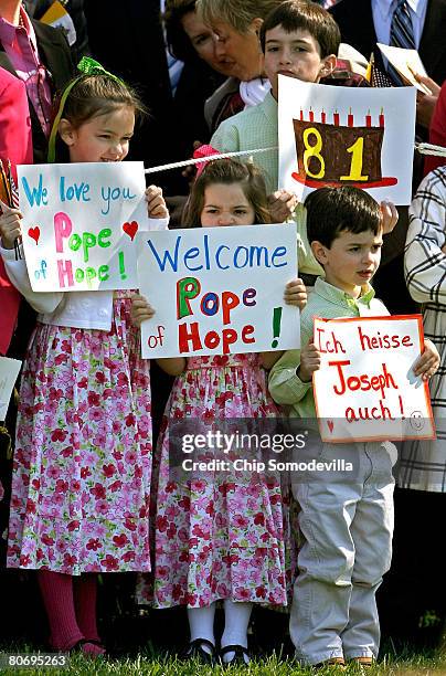 Children hold signs welcoming Pope Benedict XVI and wishing him a happy 81st birthday at the White House during an arrival ceremony on the South Lawn...