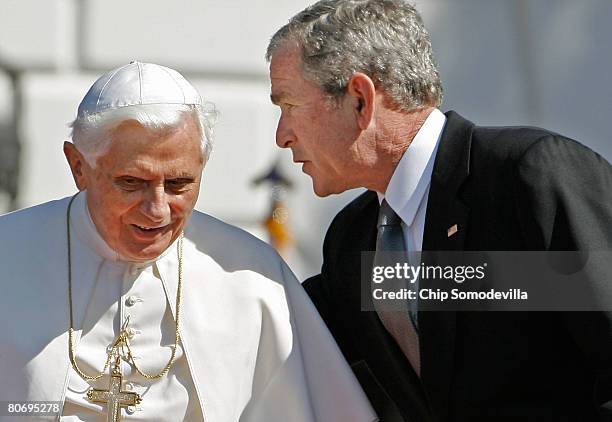 Pope Benedict XVI shares a word with U.S. President George W. Bush during an arrival ceremony on the South Lawn at the White House April 16, 2008 in...