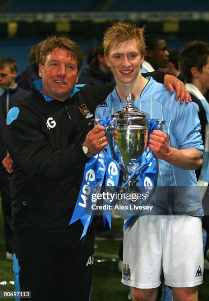 Alex Gibson, the youth team manager, and Ben Mee, the captain of Manchester City, hold the FA Youth Cup after victory over Chelsea in the FA Youth...