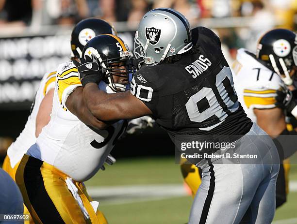 Pittsburgh center Chukky Okobi battles it out with Oakland defensive tackle Terdell Sands as the Oakland Raiders defeated the Pittsburgh Steelers by...