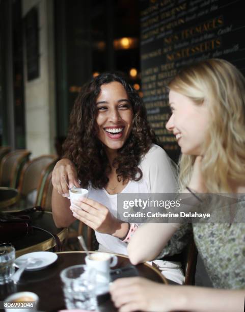 2 young women to the terrace of a parisian coffee - two cups of coffee stock pictures, royalty-free photos & images