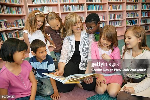 teacher reading to her students - edmonton library stock pictures, royalty-free photos & images