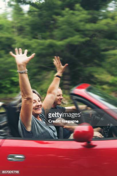 mother and son in a convertible - red car stock pictures, royalty-free photos & images