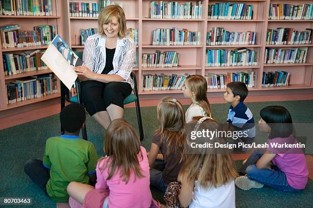 teacher and students in a library - edmonton library stock pictures, royalty-free photos & images