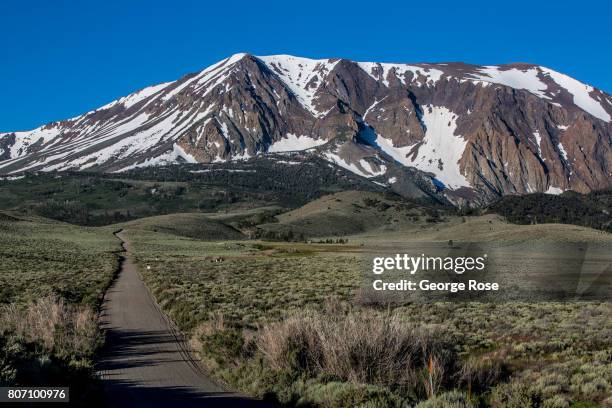 Layer of snow covering the mountains along Highway 120 up to Tioga Pass is viewed on June 28 near Lee Vining, California. Following a five-year...