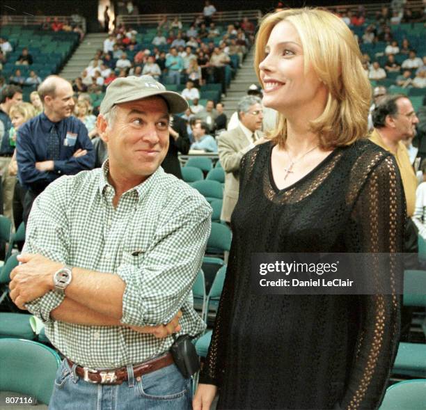 Singer Jimmy Buffett talks to Sylvester Stallone's wife Jennifer Flavin before game one of the NBA playoffs at the Miami Arena as the New York Knicks...