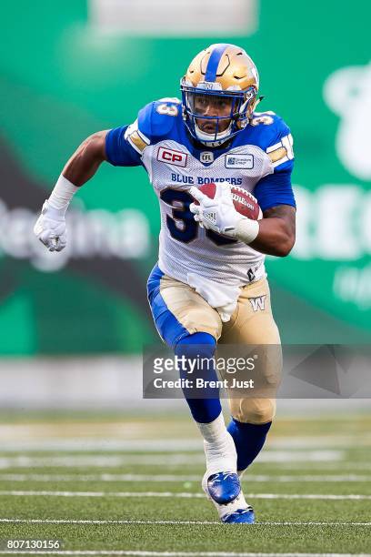 Andrew Harris of the Winnipeg Blue Bombers rushes the ball in the game between the Winnipeg Blue Bombers and Saskatchewan Roughriders at Mosaic...