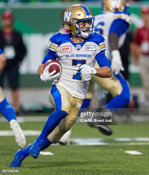 Weston Dressler of the Winnipeg Blue Bombers runs with the ball in the game between the Winnipeg Blue Bombers and Saskatchewan Roughriders at Mosaic...