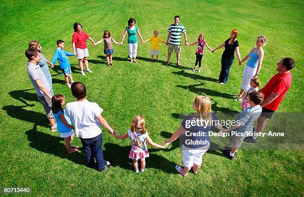 group holding hands in a circle - edmonton people stock pictures, royalty-free photos & images