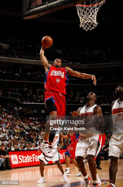 Andre Iguodala of the Philadelphia 76ers shoots against Emeka Okafor and Jason Richardson of the Charlotte Bobcats on April 16, 2008 at the Time...