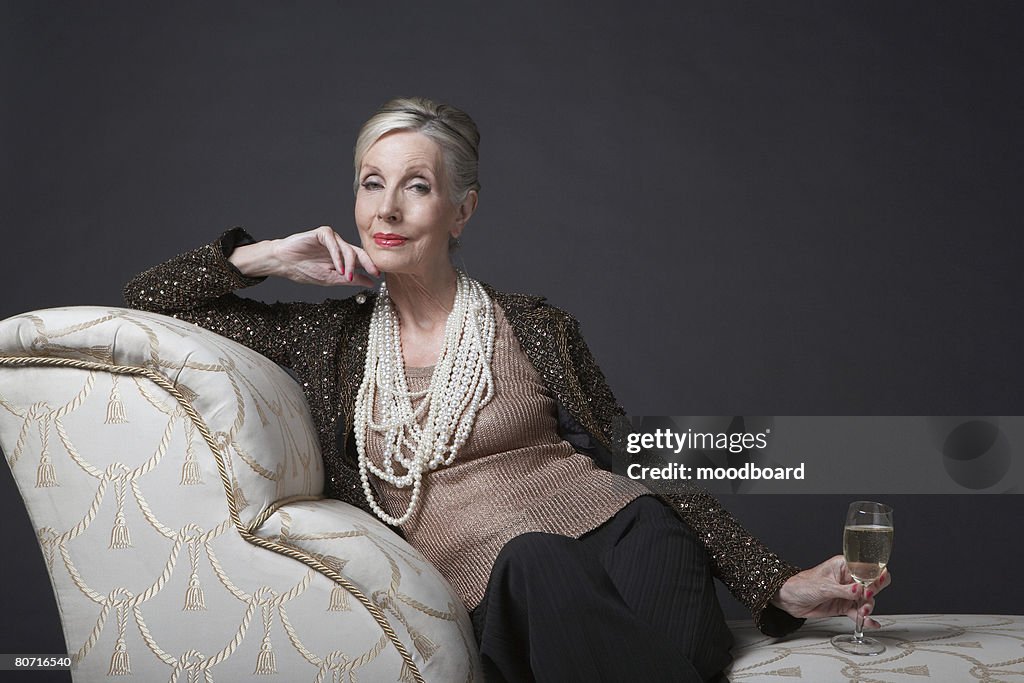 Mature Woman Having Glass of Champagne