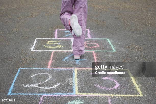 girl playing hopscotch - hopscotch stock pictures, royalty-free photos & images
